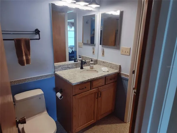 a bathroom with a toilet sink and mirror