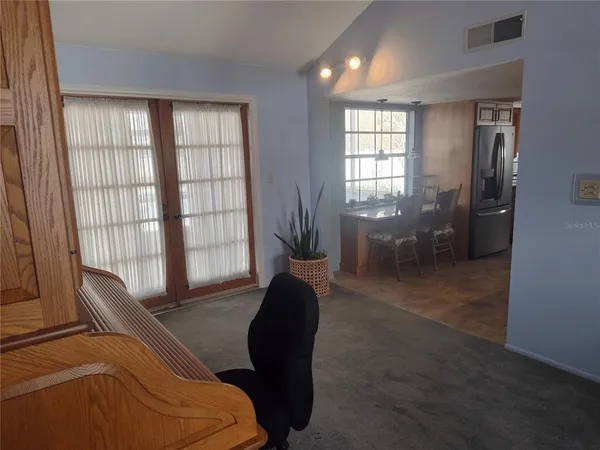 a living room with furniture and a chair