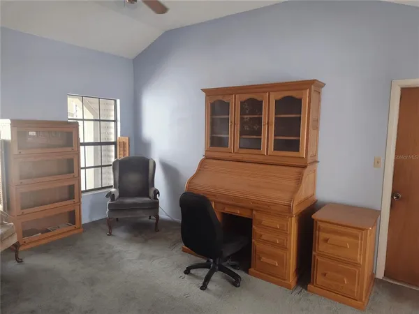 a bedroom with a bed lamp and window