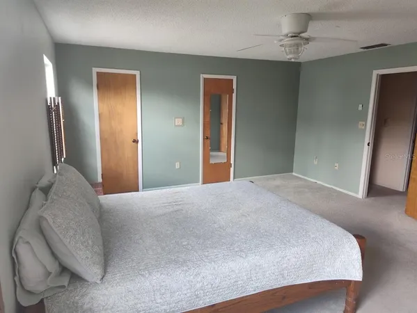 an empty room with windows and closet