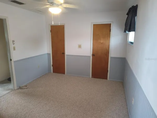 a white toilet sitting next to a bath tub