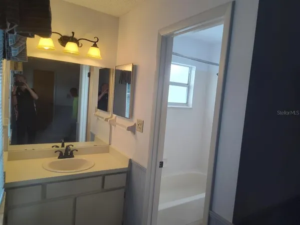a bedroom with furniture and a large window