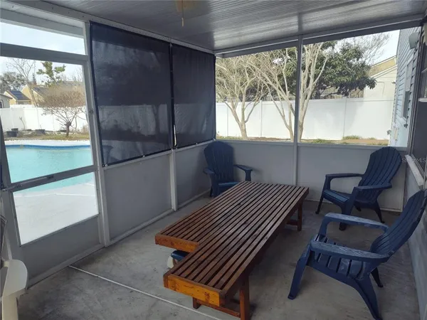 a view of a house with swimming pool and sitting area