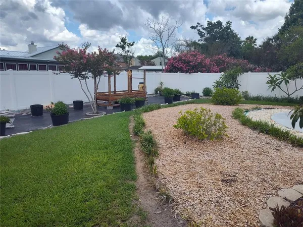 a view of an outdoor dining space with a table and chairs