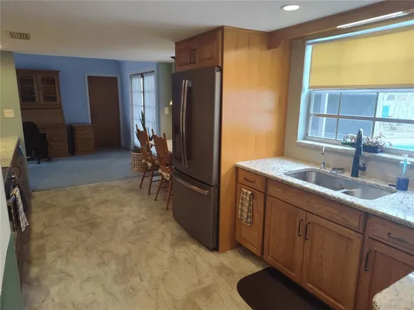 a kitchen with sink and refrigerator