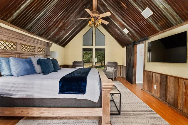 a living room with furniture a flat screen tv and a rug