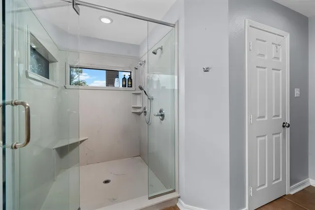 a bathroom with a glass shower door