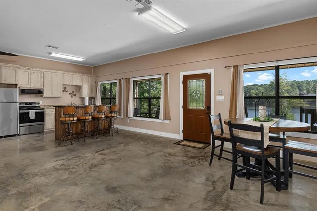 a view of a dining room with furniture and a window