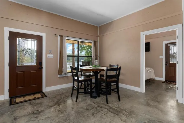 a view of a dining room with furniture and window
