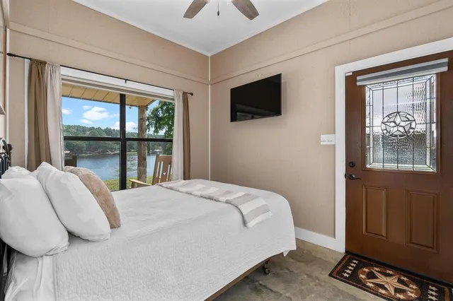 a bedroom with a bed and a tv