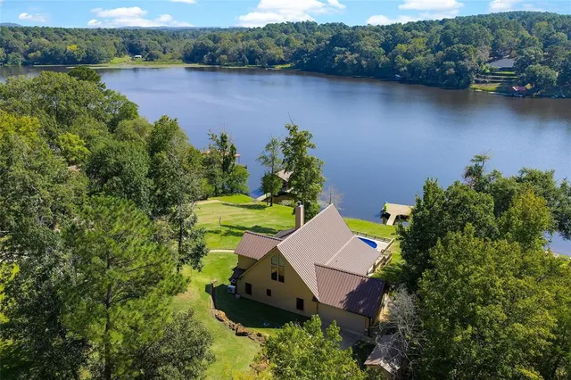 an aerial view of a house with outdoor space and lake view