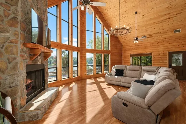 a view of a patio with couches chairs and a fireplace