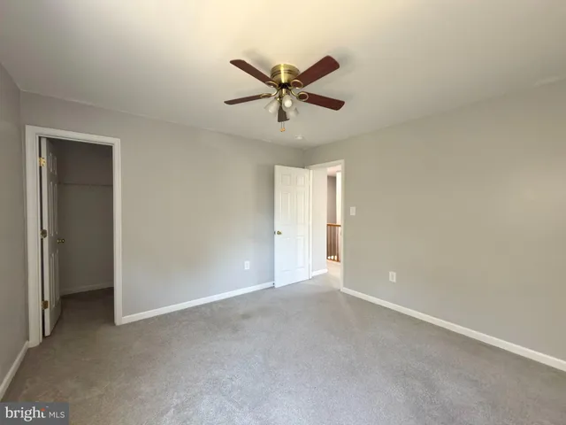 a view of a livingroom with a ceiling fan and window