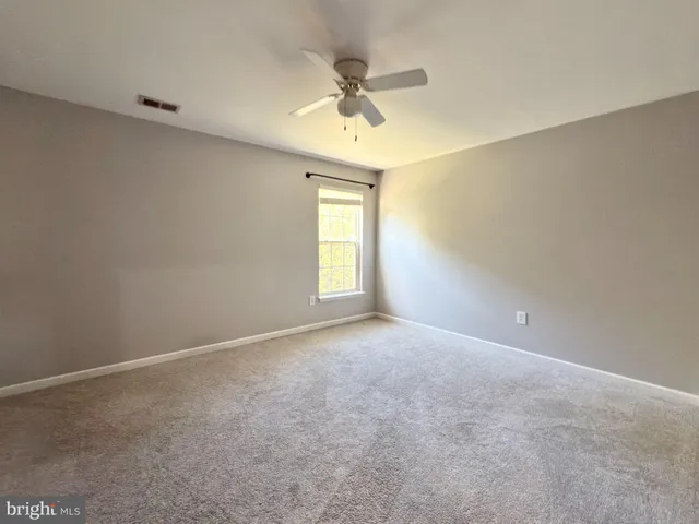a bathroom with a bathtub shower sink vanity and toilet