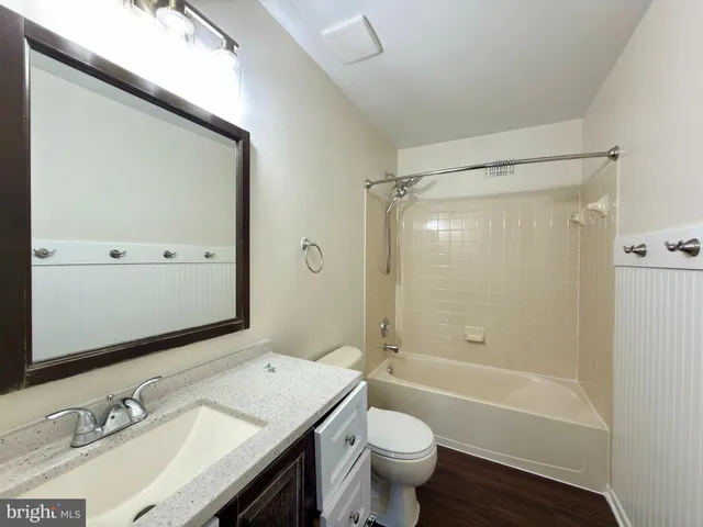 an empty room with a ceiling fan and window