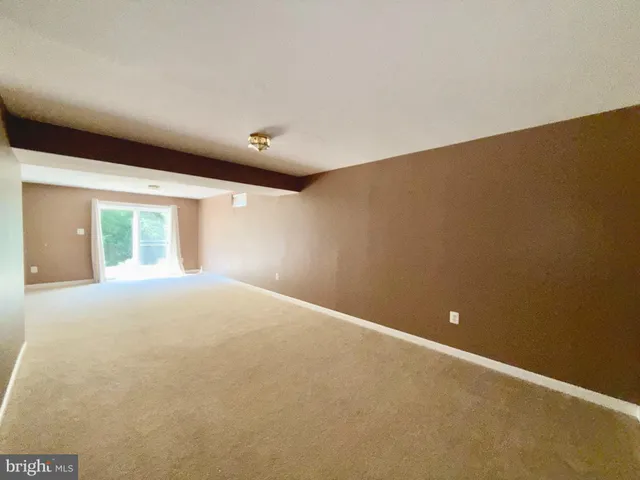 a view of a big room with closet and windows