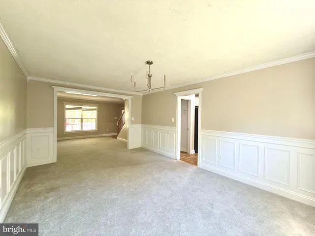 a view of an empty room with a fireplace