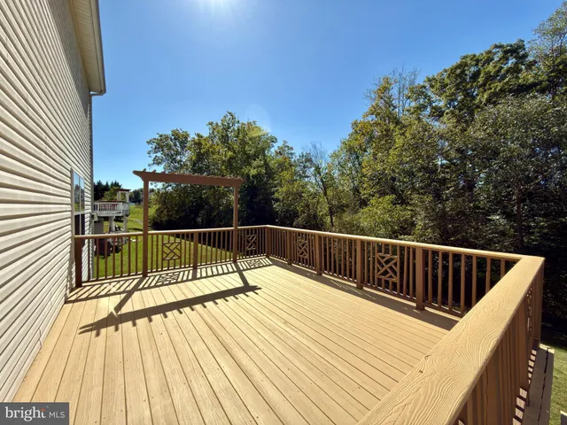 a view of balcony with wooden floor and fence