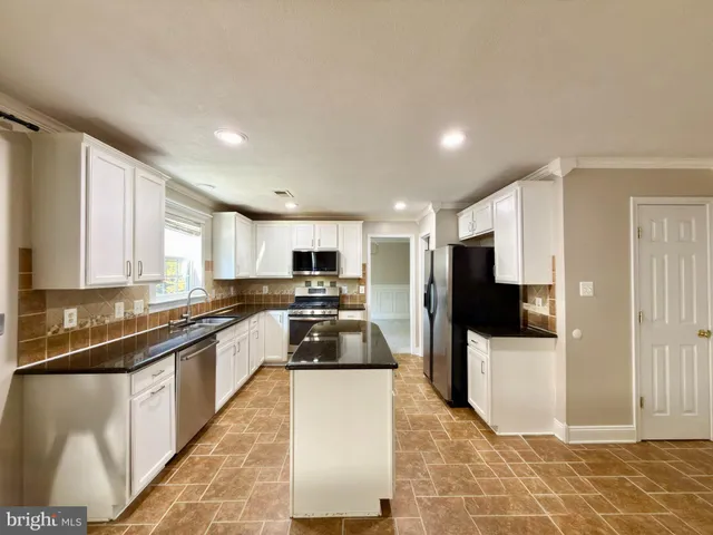 a kitchen with a sink stove and refrigerator