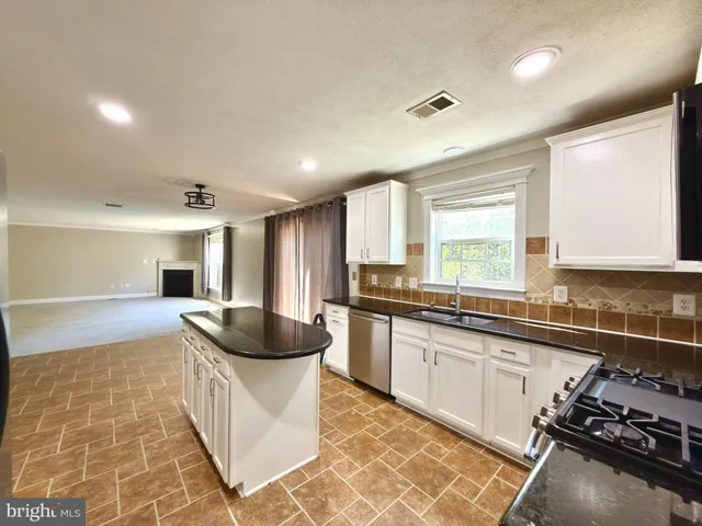 a view of a livingroom with furniture and a fireplace