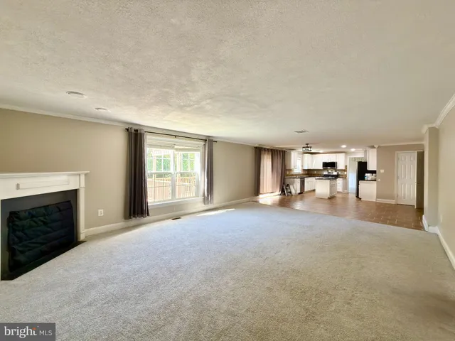 a view of an empty room with stairs