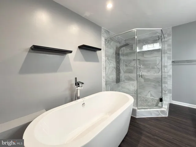 a bathroom with a double vanity sink toilet and shower