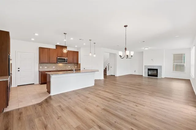 a large kitchen with kitchen island a sink stainless steel appliances and cabinets