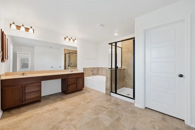 a large bathroom with a tub a double vanity sink and mirror
