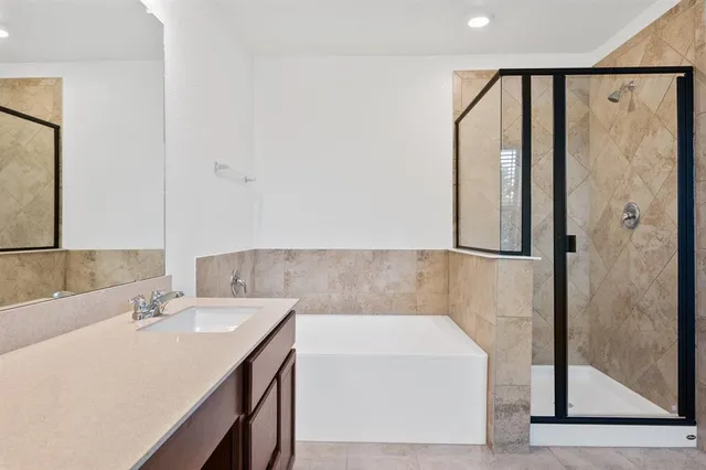 a bathroom with a sink a mirror and a bathtub