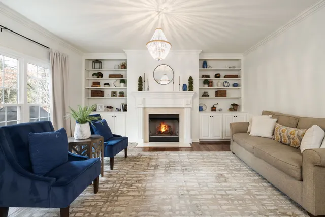 a kitchen with stainless steel appliances granite countertop a stove top oven a sink a dining table and chairs