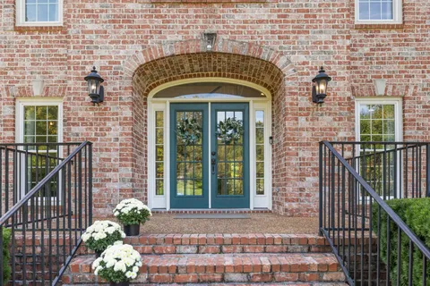 a view of an entryway with wooden floor and a fireplace