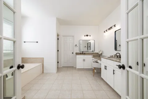 a bathroom with a white a shower curtain and a sink
