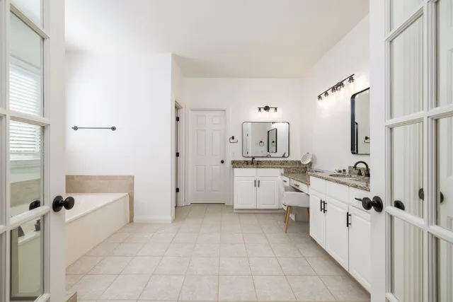 a bathroom with a white a shower curtain and a sink