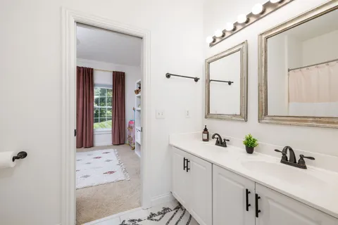an aerial view of a house with swimming pool and trees all around