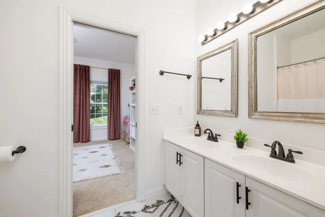 an aerial view of a house with swimming pool and trees all around