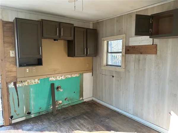 a kitchen with a refrigerator and a microwave