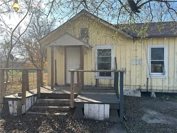 a front view of a house with wooden fence