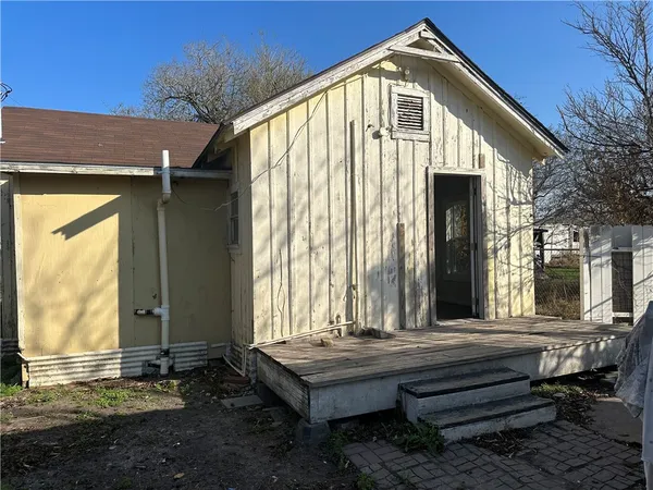 a front view of a house with a wooden floor and a porch