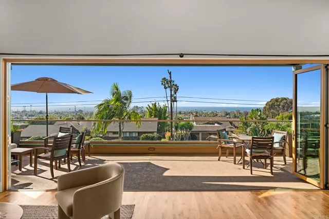 a dining room with furniture and a floor to ceiling window