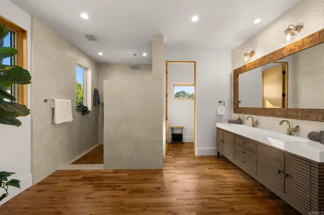 a bathroom with a sink toilet a mirror and shower