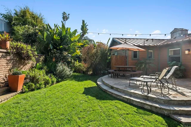a view of a swimming pool with outdoor seating and furniture