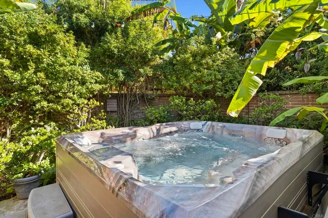 a view of a house with backyard sitting area and swimming pool