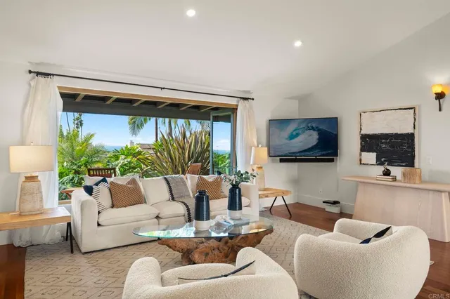 a living room with furniture and a large mirror