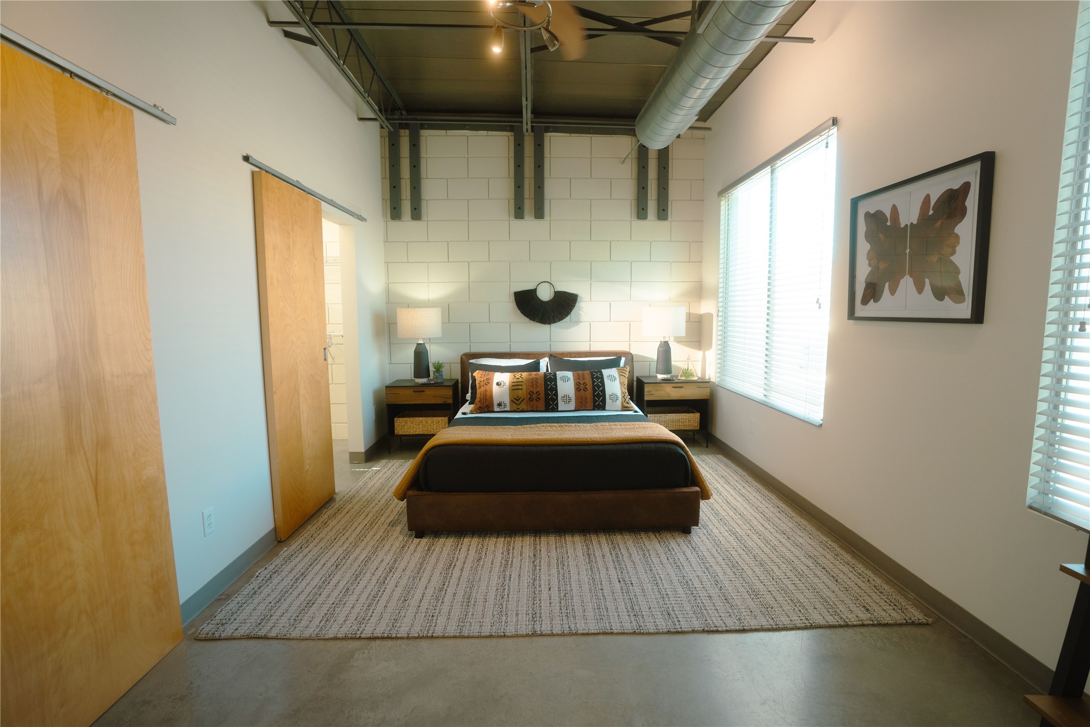 4801 South Congress Avenue, Unit H5 Austin, TX 78745 - Photo 19 of 39 Bedroom featuring concrete floors and baseboards