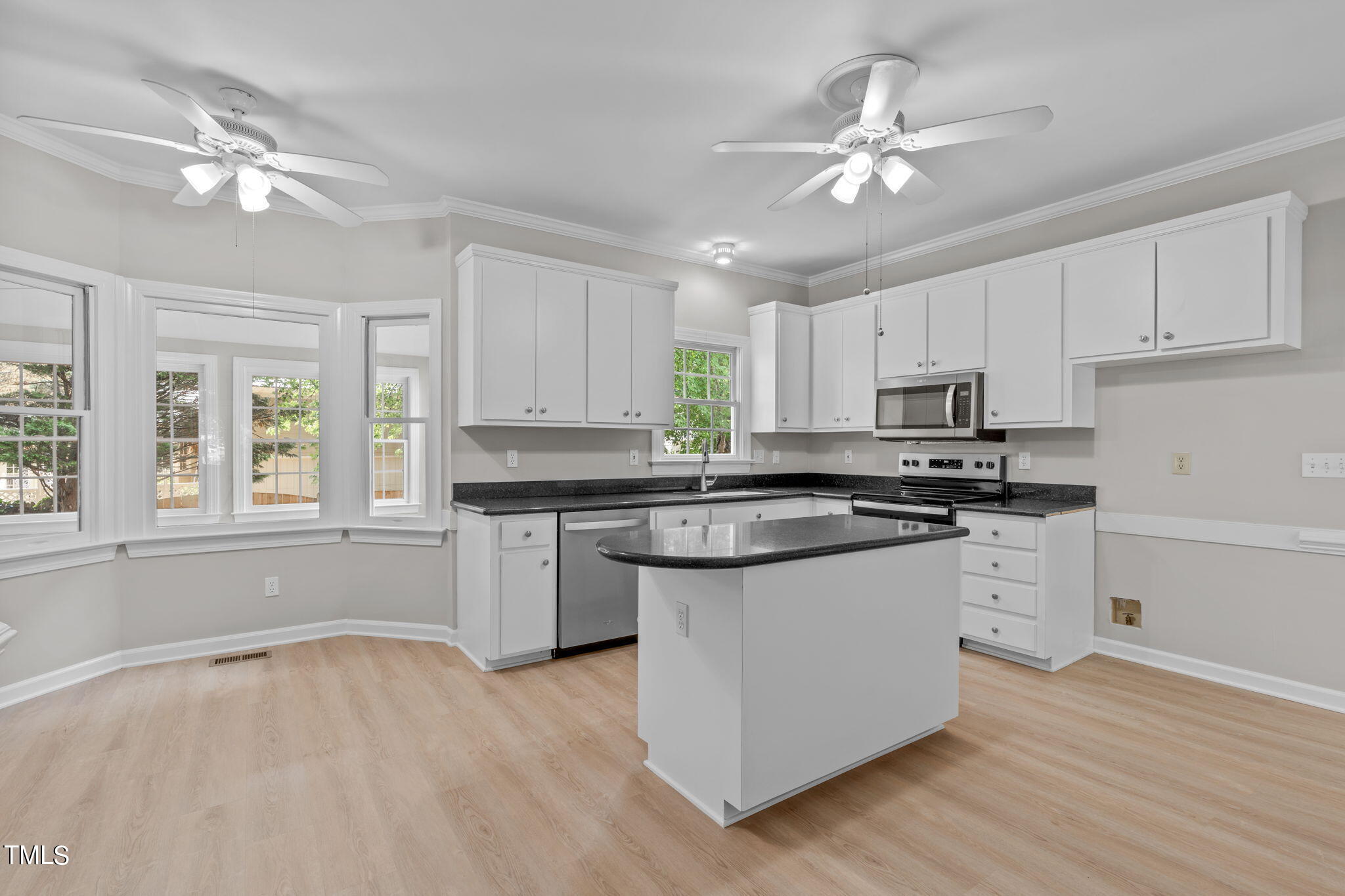 206 Palace Green Cary, NC 27518 - Photo 13 of 51 a kitchen with stainless steel appliances granite countertop a sink cabinets and wooden floor
