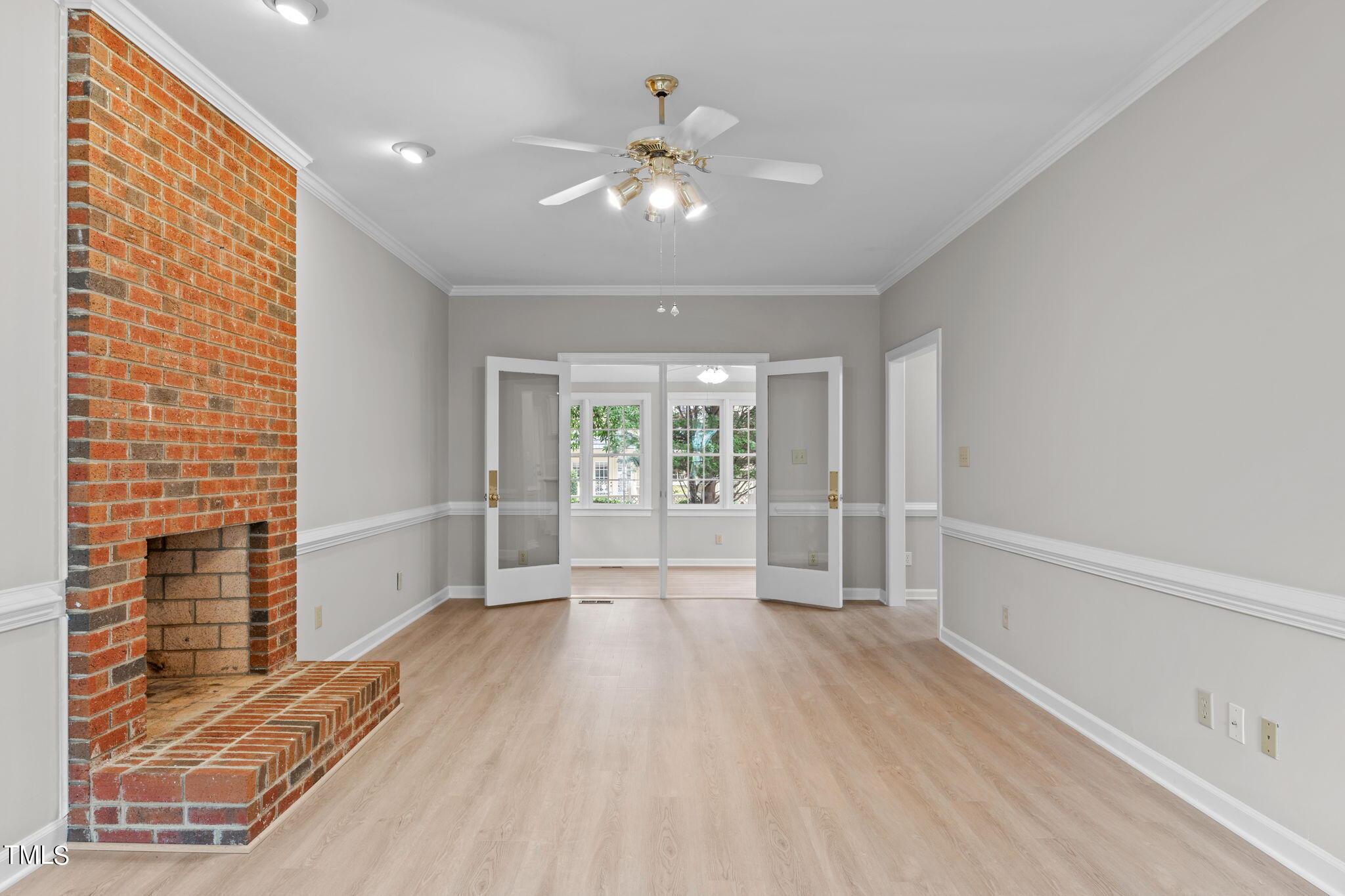 206 Palace Green Cary, NC 27518 - Photo 17 of 51 a view of an empty room with wooden floor and a window