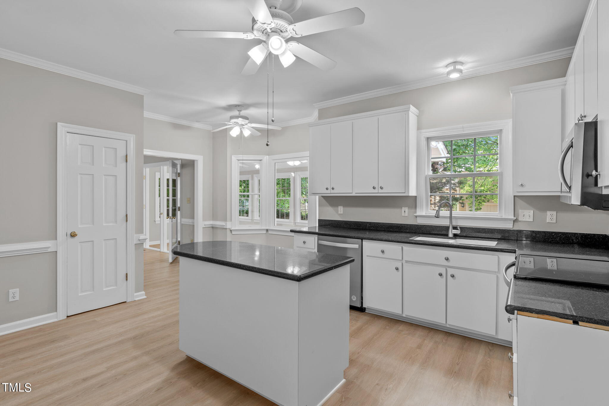 206 Palace Green Cary, NC 27518 - Photo 9 of 51 a kitchen with granite countertop stainless steel appliances a sink cabinets and wooden floor