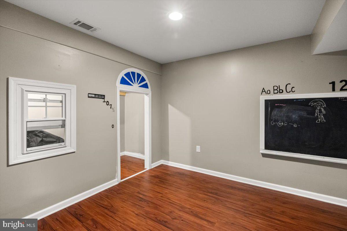 107 Gloucester Road Front Royal, VA 22630 - Photo 14 of 22 a view of an empty room with wooden floor and a window