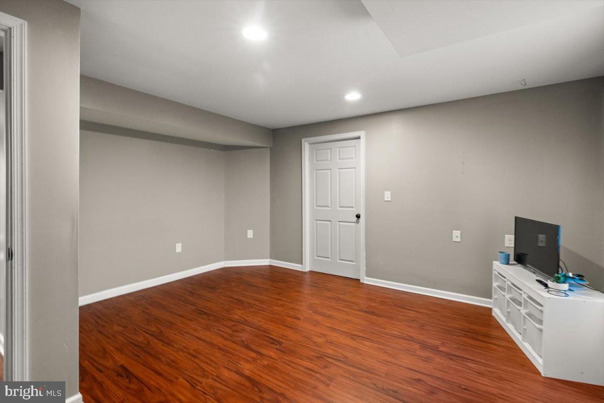 107 Gloucester Road Front Royal, VA 22630 - Photo 16 of 22 a view of an empty room with wooden floor and a flat screen tv