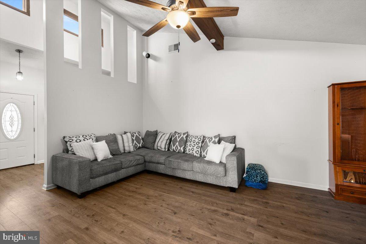 107 Gloucester Road Front Royal, VA 22630 - Photo 3 of 22 a living room with couches a coffee table and a fireplace